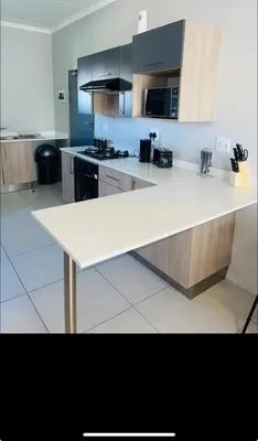 a kitchen with a white counter top in a room at Dubai 8 in Midrand