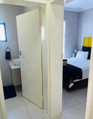 a bedroom with a door leading to a bed at Dubai 8 in Midrand