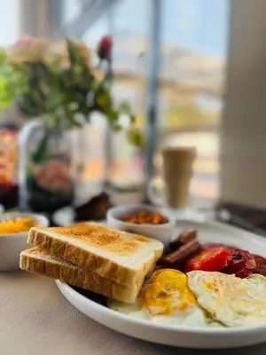 a plate of breakfast food with toast and eggs at Monet Guesthouse in Marble Hall