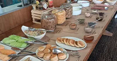 a table topped with plates of food and bowls of food at ANEW Hotel & Convention Centre OR Tambo Johannesburg in Benoni