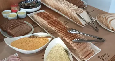 a table with different types of bread and other foods at ANEW Hotel & Convention Centre OR Tambo Johannesburg in Benoni