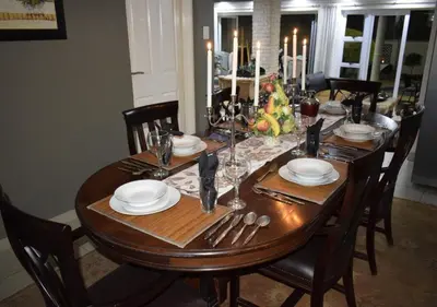 a dining room table with a christmas tree on it at The Flamingo Suite at Frederick's Place in Pretoria