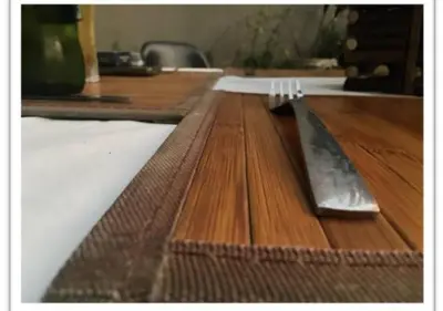 a knife and fork sitting on top of a wooden table at The Flamingo Suite at Frederick's Place in Pretoria