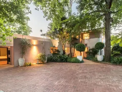 an exterior view of a house with a brick driveway at Loerie's Nest in Pretoria