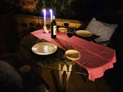 a table with two glasses and a bottle of wine at Loerie's Nest in Pretoria