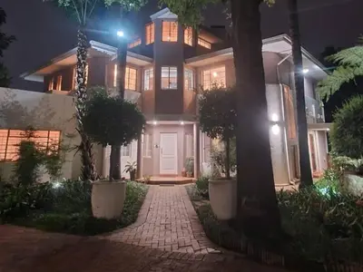 a house at night with a brick driveway at Loerie's Nest in Pretoria
