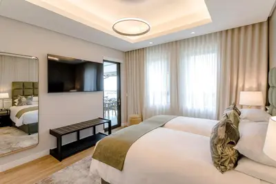 a hotel room with a bed and a television at Steyn City Hotel by Saxon in Midrand