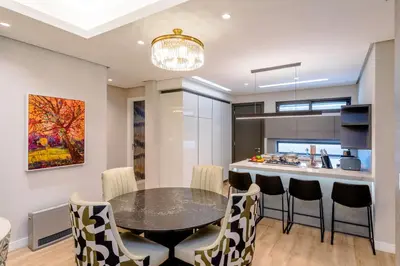 a kitchen and dining room with a table and chairs at Steyn City Hotel by Saxon in Midrand
