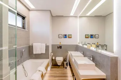 a bathroom with two sinks and a tub and a shower at Steyn City Hotel by Saxon in Midrand