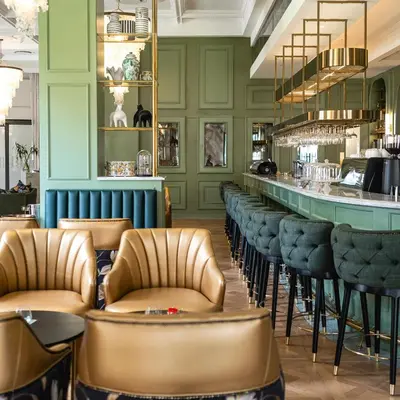 a bar with leather chairs and a counter in a restaurant at Steyn City Hotel by Saxon in Midrand