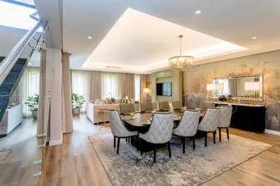 a dining room and living room with a table and chairs at Steyn City Hotel by Saxon in Midrand
