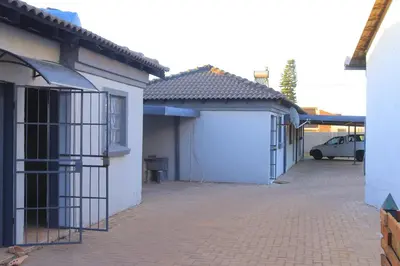 a row of houses with a garage and a car at Zone 4 Motel in Polokwane