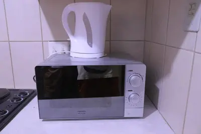 a coffee pot sitting on top of a microwave at Zone 4 Motel in Polokwane