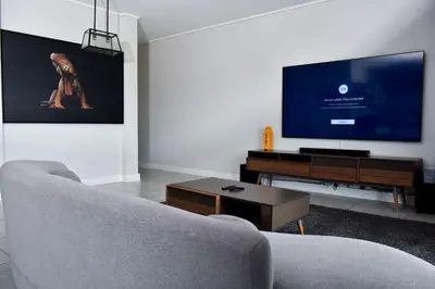 a living room with a couch and a flat screen tv at Feelathome in Midrand