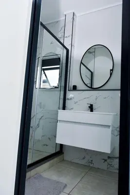 a bathroom with a sink and a mirror at Feelathome in Midrand