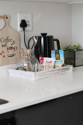 a kitchen counter with a counter top with a coffee maker at Lizzy's Residence in Midrand