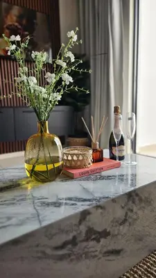 a vase with flowers in it sitting on a table at Lizzy's Residence in Midrand