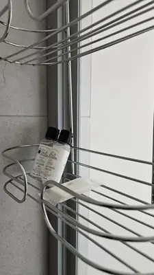 a glass shelf with two cell phones on it at Lizzy's Residence in Midrand