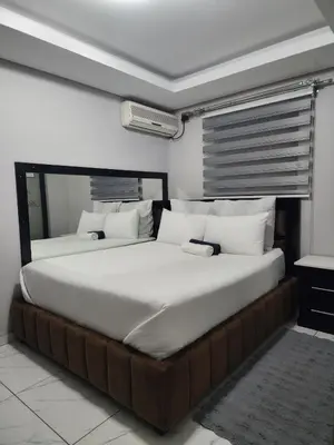 a bedroom with a large bed with white pillows at Duplessis Lodge in Kempton Park