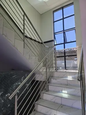 a set of stairs in a building with a window at Duplessis Lodge in Kempton Park