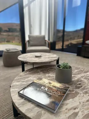 a coffee table with a book on it in a living room at Rattlesnake Weir in Dullstroom