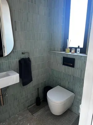 a bathroom with a toilet and a sink and a mirror at Rattlesnake Weir in Dullstroom