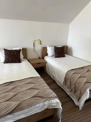 a room with two beds and a lamp at Rattlesnake Weir in Dullstroom