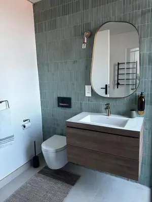 a bathroom with a sink and a toilet and a mirror at Rattlesnake Weir in Dullstroom
