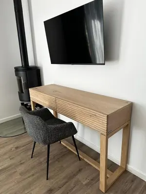 a wooden desk with a chair and a television on a wall at Rattlesnake Weir in Dullstroom