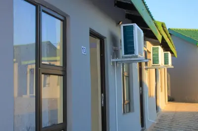 a building with a window and a door with a air conditioner at Vuyani Guest Lodge in Malamulele