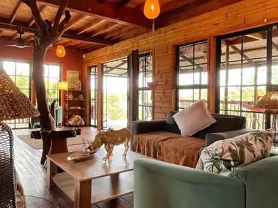 a living room with a couch and a table at Croc's Nest Bush Lodge in Marloth Park