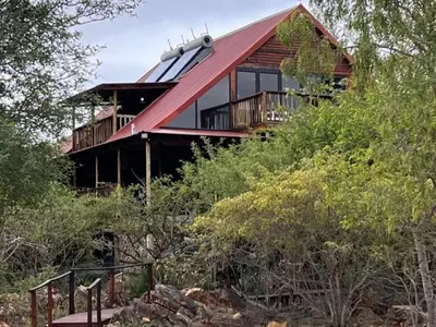 a house with a red roof on a hill at Croc's Nest Bush Lodge in Marloth Park