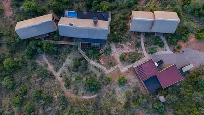 an overhead view of a house with two roofs at Cliffhanger Lodge in Mabula