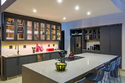 a kitchen with a large white counter top and cabinets at Cliffhanger Lodge in Mabula