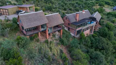 an aerial view of a house on a hill at Cliffhanger Lodge in Mabula