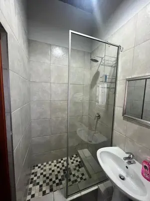 a bathroom with a shower and a sink at Two Firs Irene in Centurion