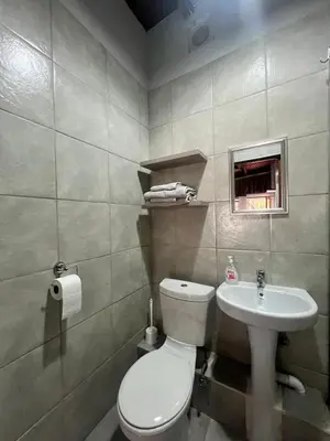 a bathroom with a white toilet and a sink at Two Firs Irene in Centurion