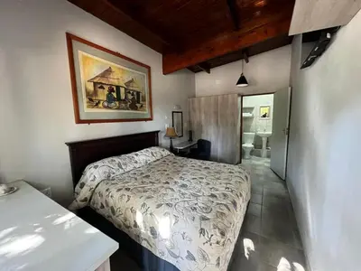 a bedroom with a bed and a picture on the wall at Two Firs Irene in Centurion