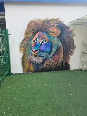 a mural of a lion painted on the side of a building at King Sanctuary in Centurion