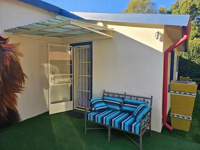a balcony with a chair on a house at King Sanctuary in Centurion