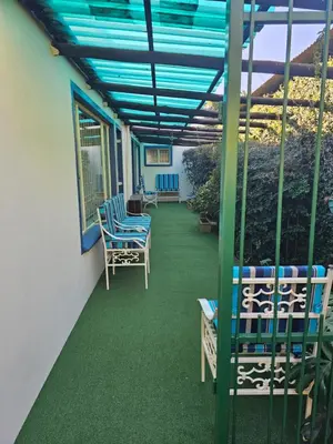 a patio with chairs and a blue roof at King Sanctuary in Centurion