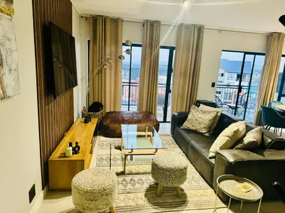 a living room with a couch and a table at The Blyde Lagoon Apartment in Pretoria