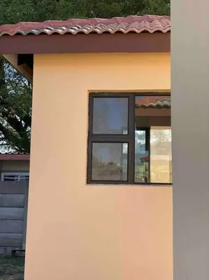 a window on the side of a house at SummerPlace - Studio Apartment with Kitchenette in Modimolle