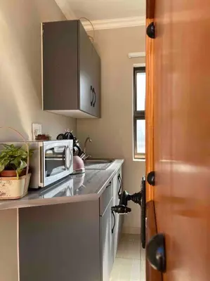 a kitchen with a counter top with a microwave at SummerPlace - Studio Apartment with Kitchenette in Modimolle