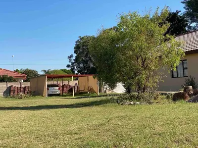a house with a tree in a yard at SummerPlace - Studio Apartment with Kitchenette in Modimolle