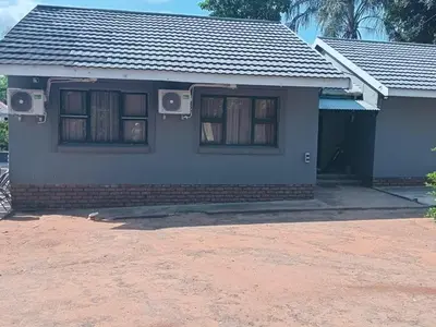 a house with two windows and a driveway at SuLo Guesthome in Phalaborwa