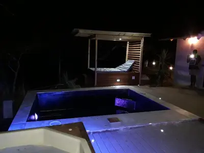 a swimming pool in the middle of a yard at night at Mokaikai - The Soaring Eagle in Mabula