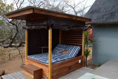 a gazebo with an umbrella on a deck at Mokaikai - The Soaring Eagle in Mabula