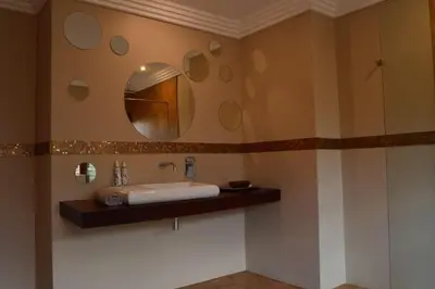 a bathroom with a sink and a mirror at Mokaikai - The Soaring Eagle in Mabula