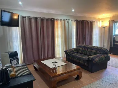 a living room with a couch and a coffee table at Pringle Studio in Benoni